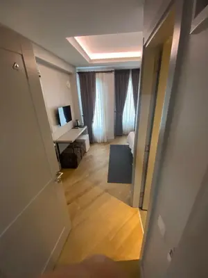 a hallway with a door open to a room at KONAK BELLA 3 in Istanbul