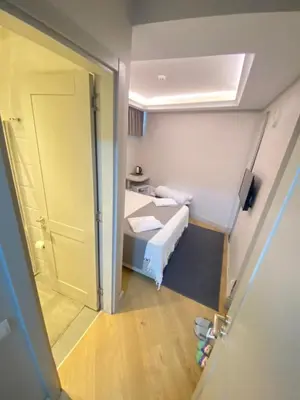 a small room with a bed and a door at KONAK BELLA 3 in Istanbul