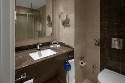 a bathroom with a sink and a mirror at Rotta Hotel Istanbul in Istanbul