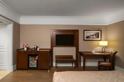 a hotel room with a bed and a desk and a television at Rotta Hotel Istanbul in Istanbul