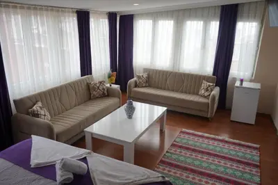 a living room with two couches and a coffee table at Medellin Apart Hotel Istanbul in Istanbul
