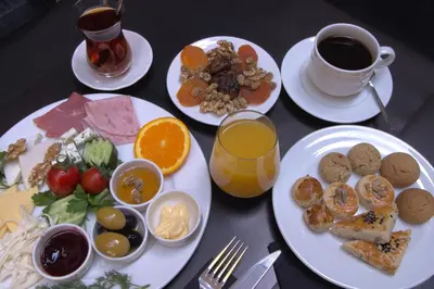 a table with plates of food and a cup of coffee at Four-G Hotel in Istanbul