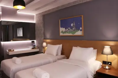 two beds in a hotel room with white sheets at Four-G Hotel in Istanbul