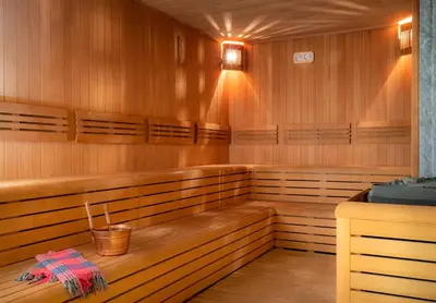a sauna with wooden seats and a bucket in it at Occidental Taksim in Istanbul