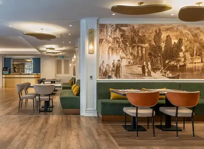 a dining room with a painting on the wall at Occidental Taksim in Istanbul