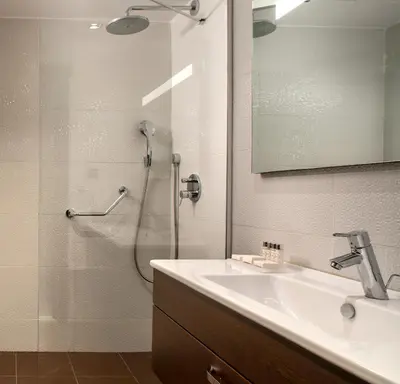 a bathroom with a shower with a sink and a shower at Occidental Taksim in Istanbul