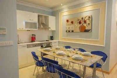 a dining room with a table and blue chairs at Three bedroom Duplex apartment with large terrace in Istanbul