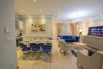 a kitchen and living room with a table and chairs at Three bedroom Duplex apartment with large terrace in Istanbul
