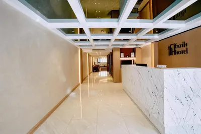 a hallway in a hotel with a marble wall at Osmanbey Fatih Hotel in Istanbul