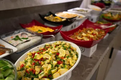 a buffet of different types of food on a counter at Four Sides Taksim Lion Hotel&Spa in Istanbul