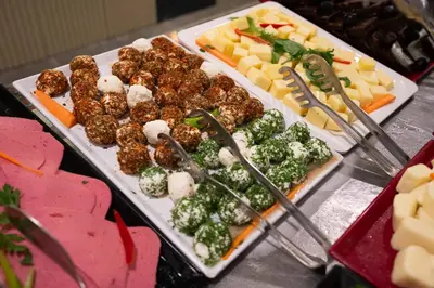 a buffet of food with meatballs and vegetables and cheese at Four Sides Taksim Lion Hotel&Spa in Istanbul