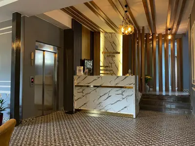 a lobby with a marble counter and a reception desk at New Taksim Hotel in Istanbul