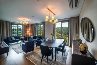 a living room with a table and chairs at Radisson Residences Vadistanbul in Istanbul