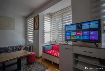 a living room with a couch and a flat screen tv at PUHU OTEL in Istanbul