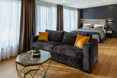 a living room with a couch and a bed at Norah Suites Hotel İstanbul in Istanbul