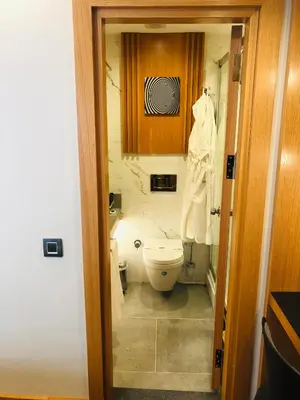 a small bathroom with a toilet and a cabinet at Maywood Hotel in Istanbul