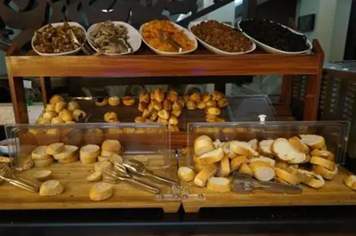 a display case in a bakery with different types of food at Maywood Hotel in Istanbul