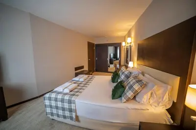 a bedroom with a large white bed with pillows at Karinna Hotel Convention Center & Spa Luxury - Full Board Plus in Uludag