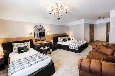 a hotel room with two beds and a couch at Karinna Hotel Convention Center & Spa Luxury - Full Board Plus in Uludag