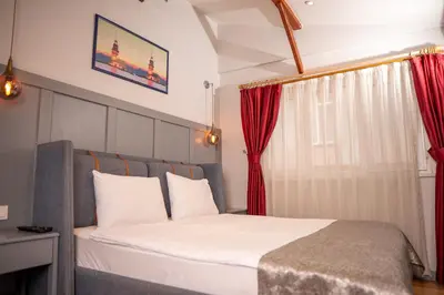 a bedroom with a large bed with red curtains at Corner Hot in Istanbul