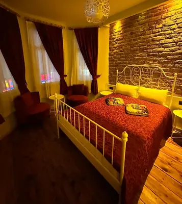 a bedroom with a bed with a brick wall at Corner Hot in Istanbul