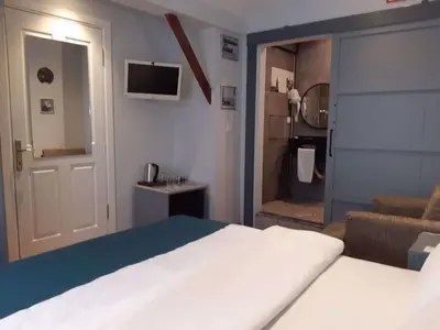 a bedroom with a large bed and a living room at Corner Hot in Istanbul