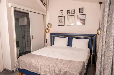 a bedroom with a blue and white bed and a shower at Corner Hot in Istanbul