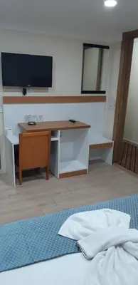 a bedroom with a desk and a television and a bed at Arya Hotel in Istanbul