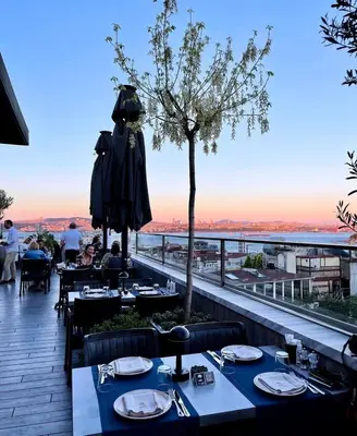 a restaurant with tables on a balcony with a view at DeCamondo Galata, a Tribute Portfolio Hotel in Istanbul