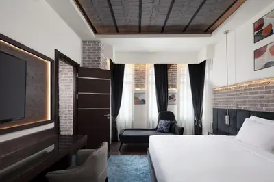 a hotel room with a bed and a tv at DeCamondo Galata, a Tribute Portfolio Hotel in Istanbul
