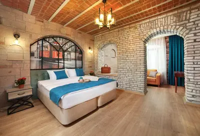 a bedroom with a large bed in a brick wall at Ardilas Residence in Istanbul