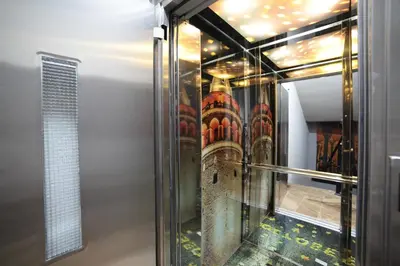 a room with a glass wall with a reflection of a building at Ardilas Residence in Istanbul