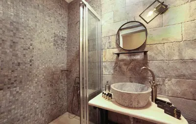a bathroom with a sink with a mirror and a shower at Ardilas Residence in Istanbul