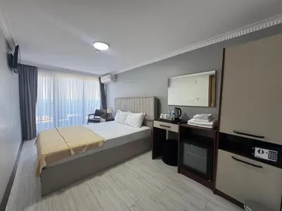 a hotel room with a bed and a television at istanbul Airport Kumsal Otel in Arnavutköy