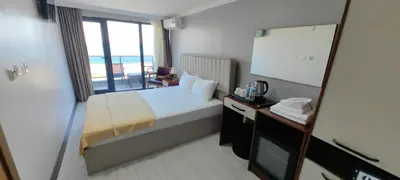 a hotel room with a bed and a mirror at istanbul Airport Kumsal Otel in Arnavutköy