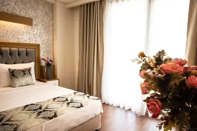 a bedroom with a bed and a large window at Eliza Hotel in Istanbul