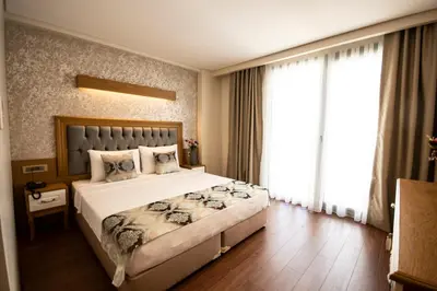 a bedroom with a large bed and a large window at Eliza Hotel in Istanbul