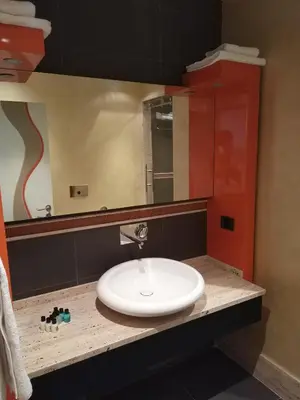 a bathroom with a white sink and a mirror at Armoni Residence & Hotel in Istanbul