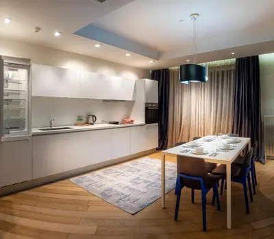 a kitchen with a table with chairs and a dining room at Armoni Residence & Hotel in Istanbul