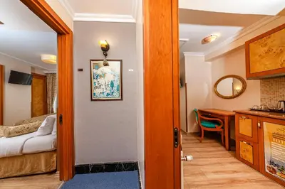 a room with a bed and a desk and a table at Santa Ottoman Hotel in Istanbul