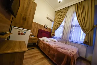 a hotel room with a bed and a window at Kosk Hotel Kadikoy in Istanbul