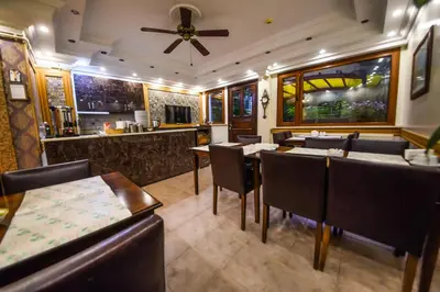 a restaurant with tables and chairs and a bar at Kosk Hotel Kadikoy in Istanbul