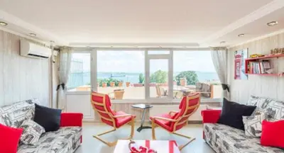 a living room with a couch and chairs and a large window at Front of Sea View Apartments Sultanahmet SEA VIEW in Istanbul