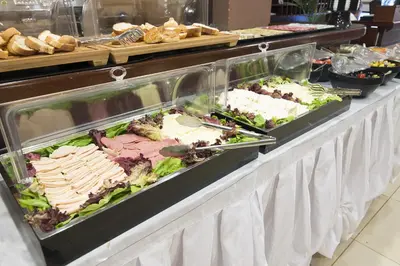 a buffet line with meats and vegetables and sandwiches at Cumbali Suite Hotel in Istanbul