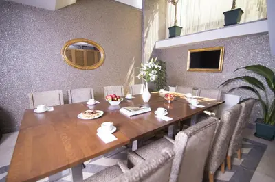 a dining room with a wooden table and chairs at Cumbali Suite Hotel in Istanbul
