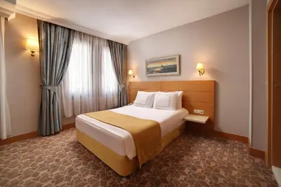 a hotel room with a large bed and a window at Almina Hotel - Special Class in Istanbul