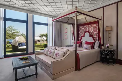 a bedroom with a canopy bed and a couch at Çırağan Palace Kempinski Istanbul in Istanbul