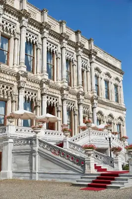 a large building with red stairs in front of it at Çırağan Palace Kempinski Istanbul in Istanbul
