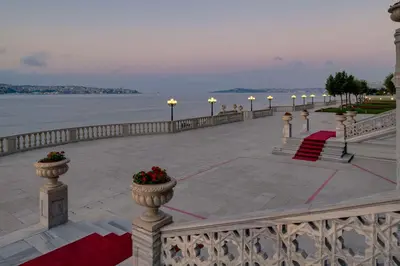 a walkway with a view of the water and a pier at Çırağan Palace Kempinski Istanbul in Istanbul