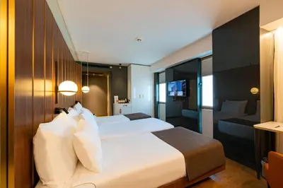 a bedroom with a large white bed and a couch at The Craton Hotel Sisli in Istanbul